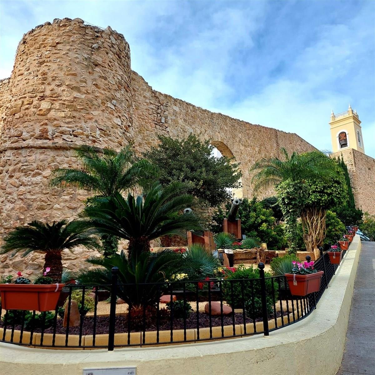 Historic stone walls and gardens in Calpe Old Town
