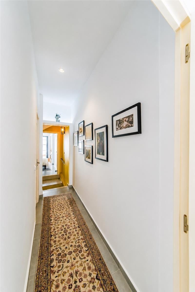 Casa Toro hallway with framed artwork and patterned runner