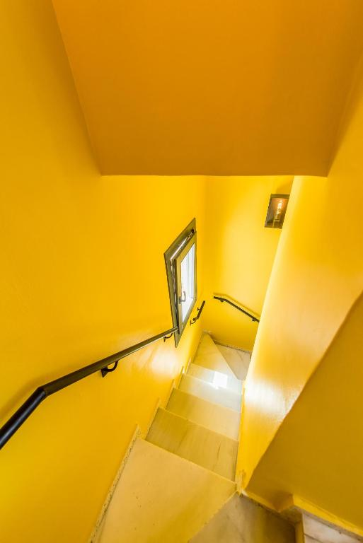 Casa Toro yellow stairwell connecting the townhouse levels